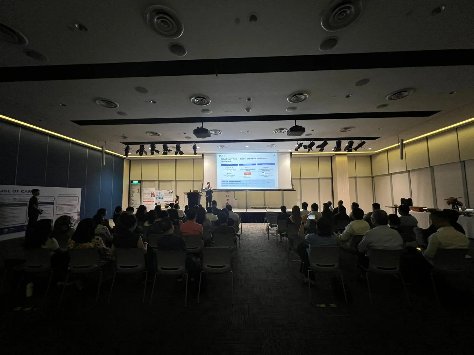 Wide view of the auditorium with a full audience attending the NTUC LearningHub Healthcare Sector event as Yau Png presents on stage