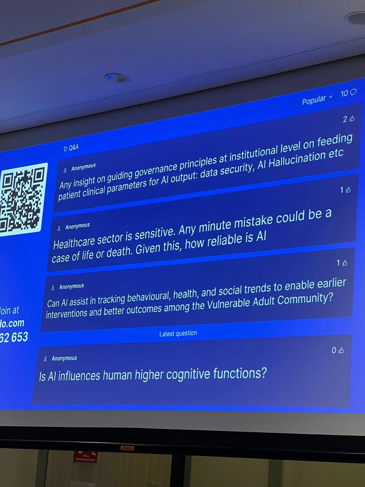 Live Q&A slide showing audience questions including concerns about AI reliability in life-or-death situations, data governance, AI hallucinations, and supporting the Vulnerable Adult Community